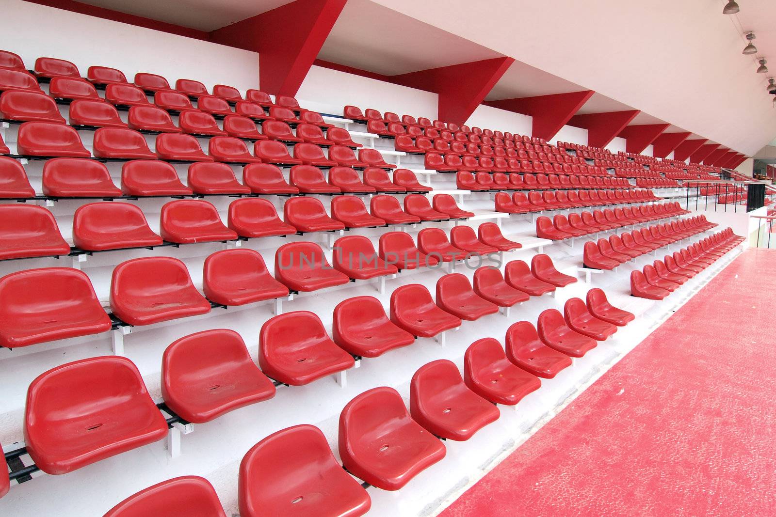 Red seat at Thep Hasadin Stadium in Thailand by jakgree