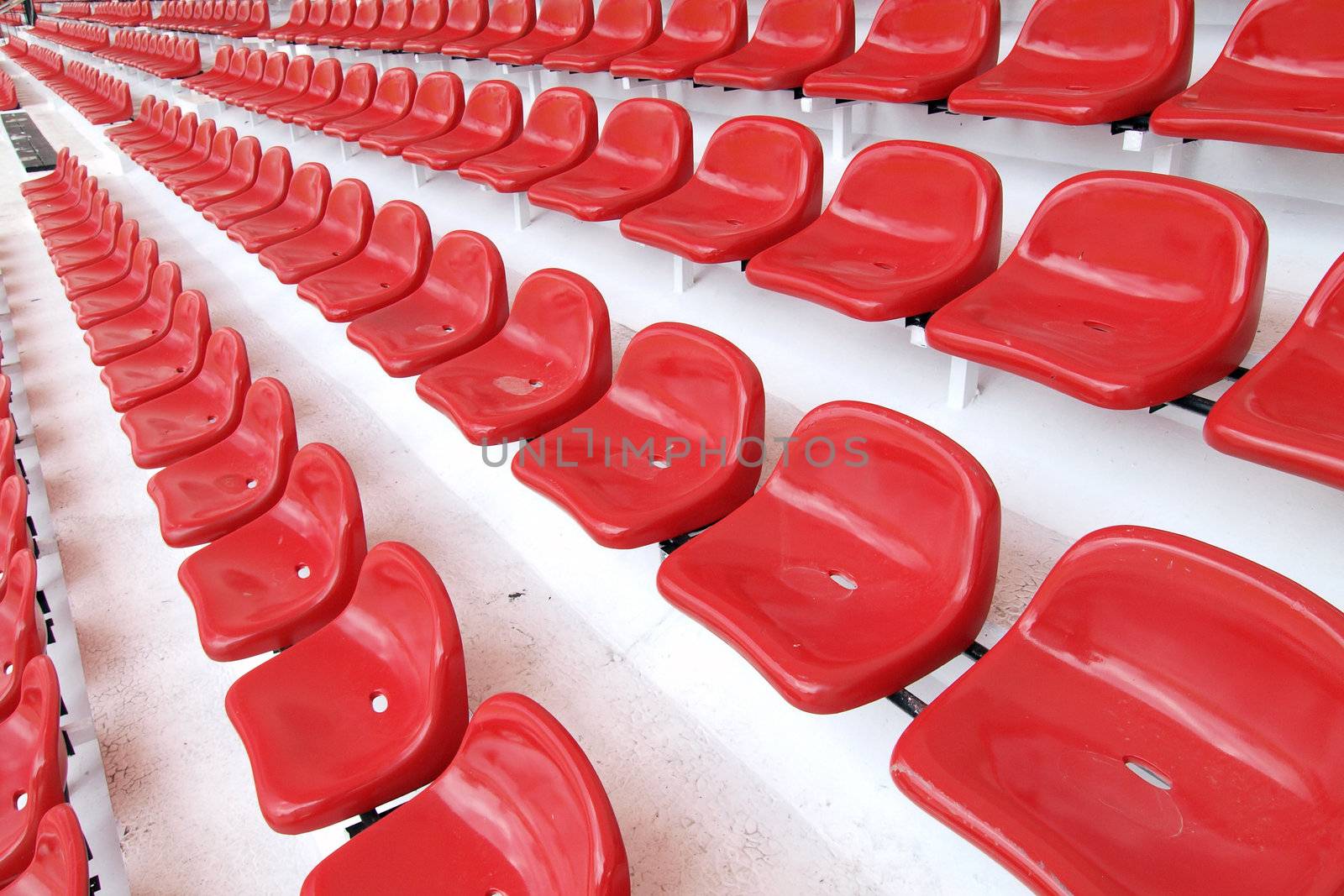 Red seat at Thep Hasadin Stadium in Thailand by jakgree