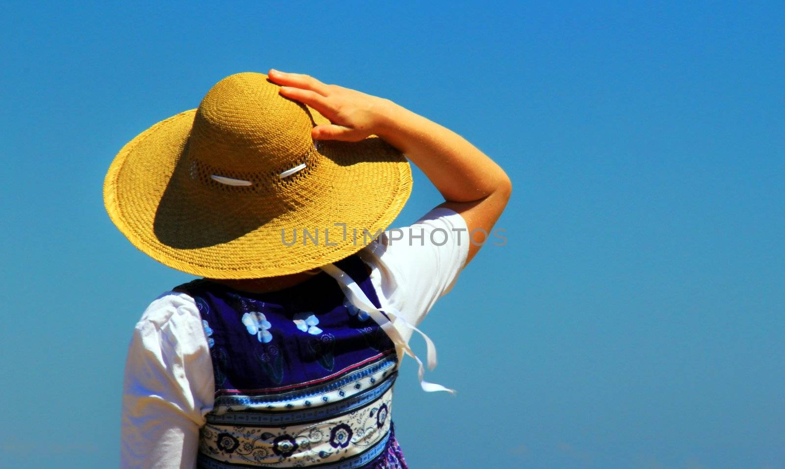 Hot sunny day. Woman is hiding with her hat.