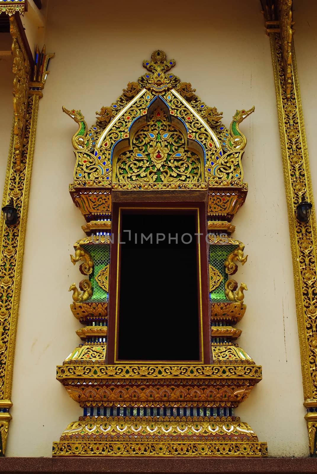 Ancient Golden carving wooden window of Thai temple in Thailand.