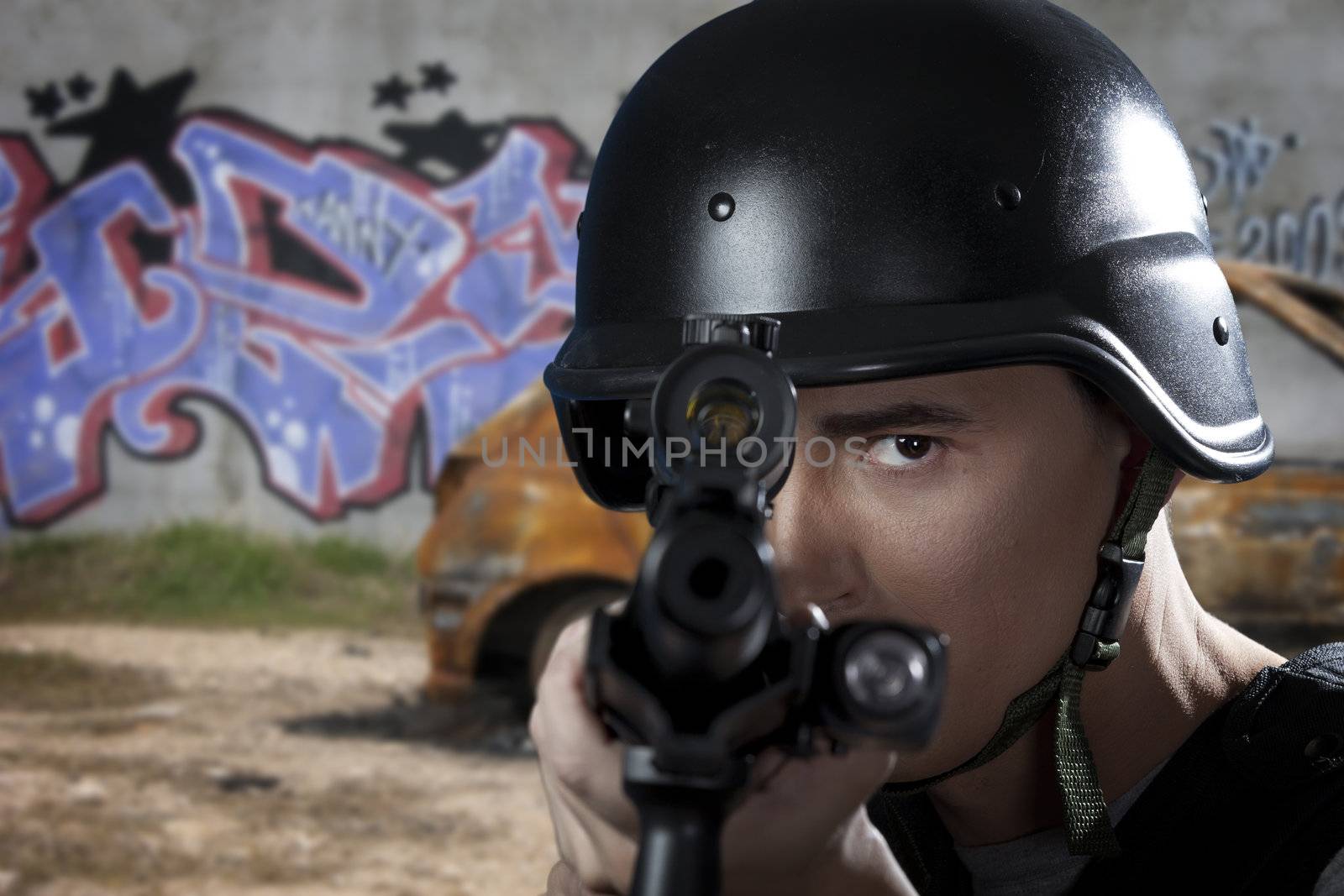 SWAT police officer aiming a shotgun