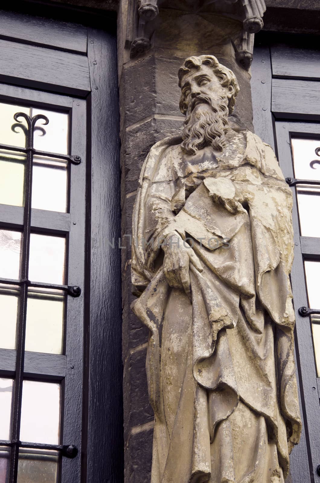 Sculpture near old library building columns sage man with beard.