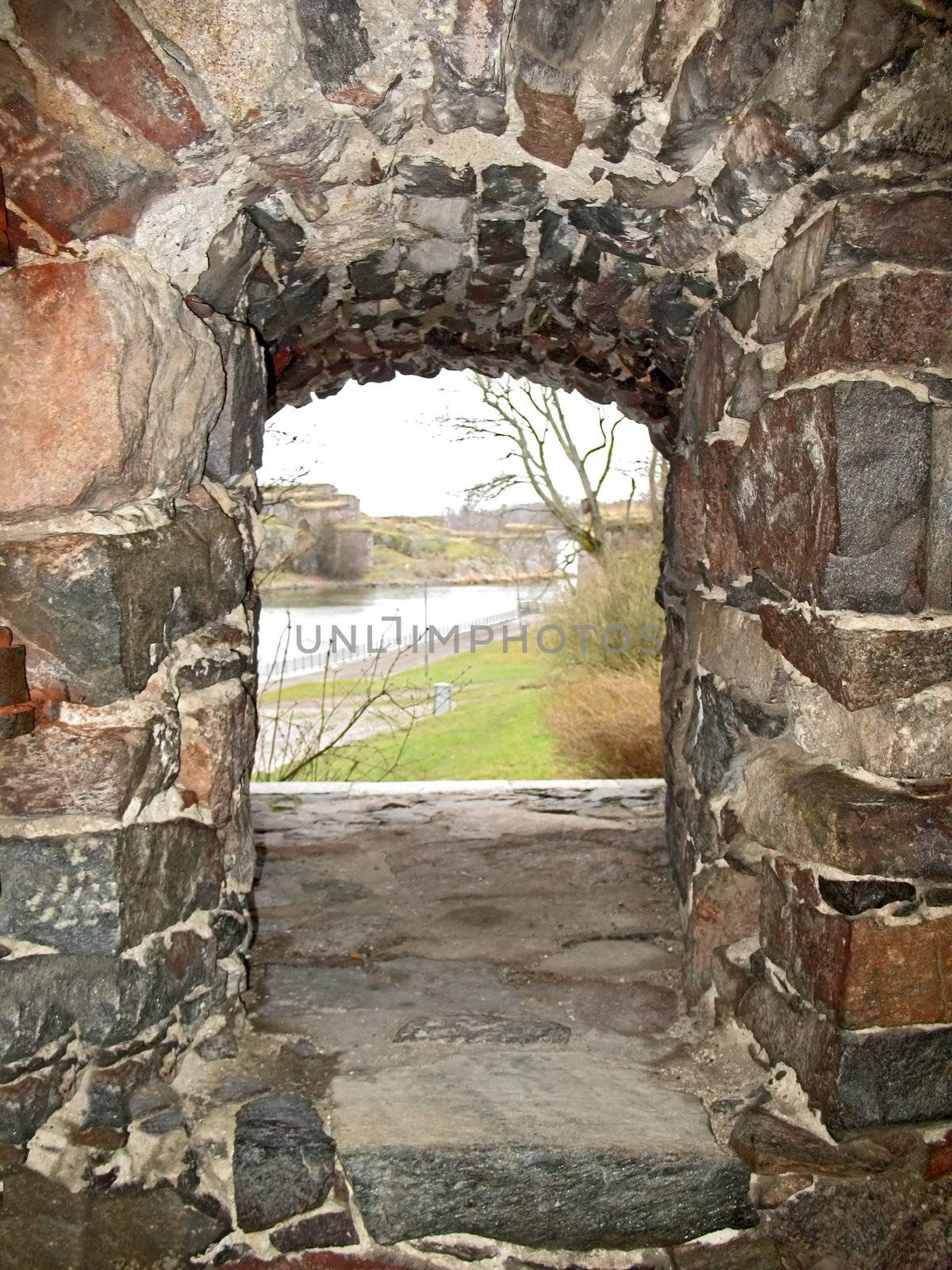 View through stone window in the wall of castle. by Vitamin