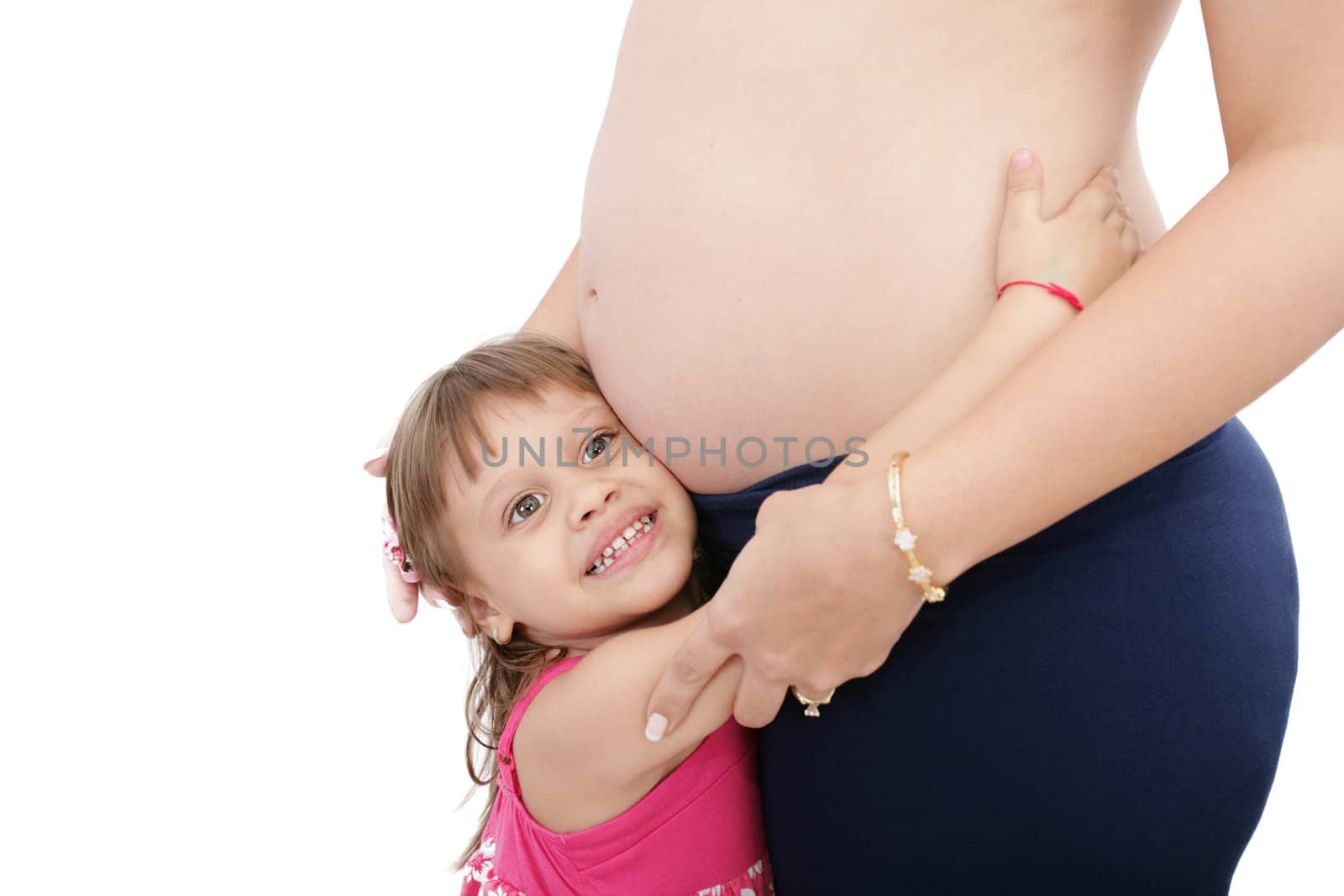Pregnant mother with her small daughter studio shot