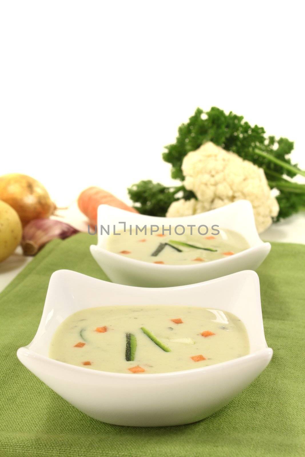 vegetable creme soup with zucchini and carrots on a light background