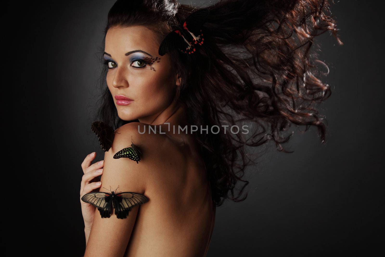 woman and butterfly on black