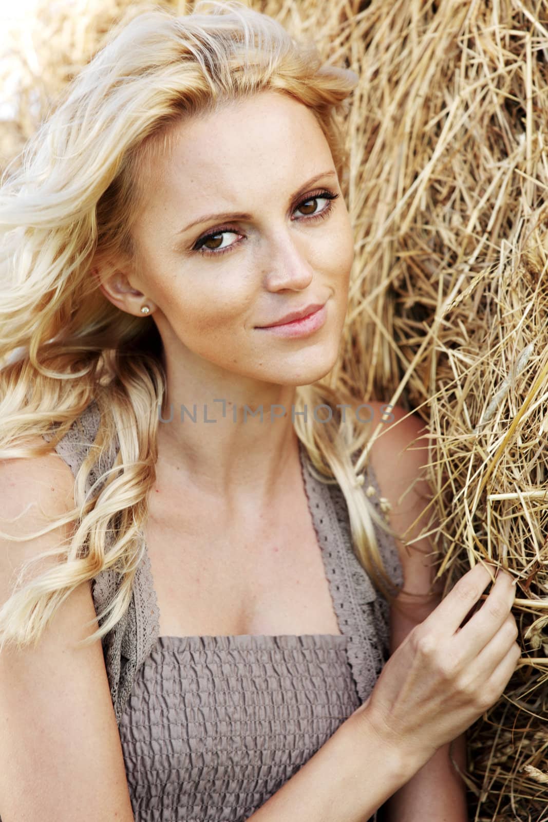 portrait of a girl next to haystack close