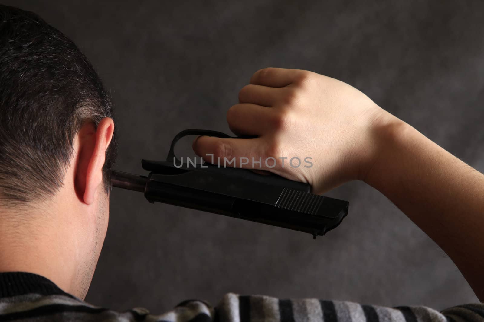 The man with a pistol on a dark background 