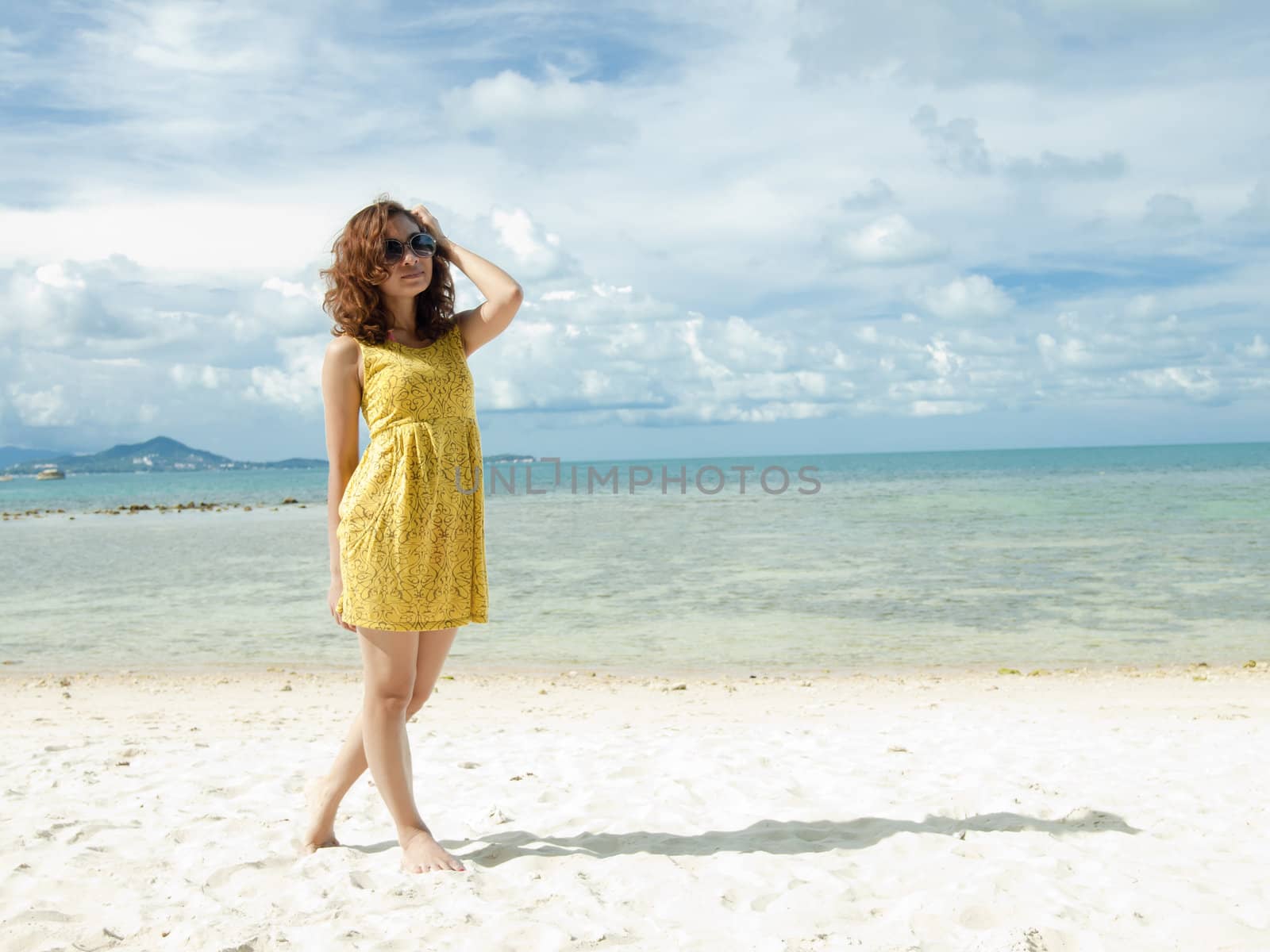 Asian Women on the Beach with vibrant yellow dress by jakgree