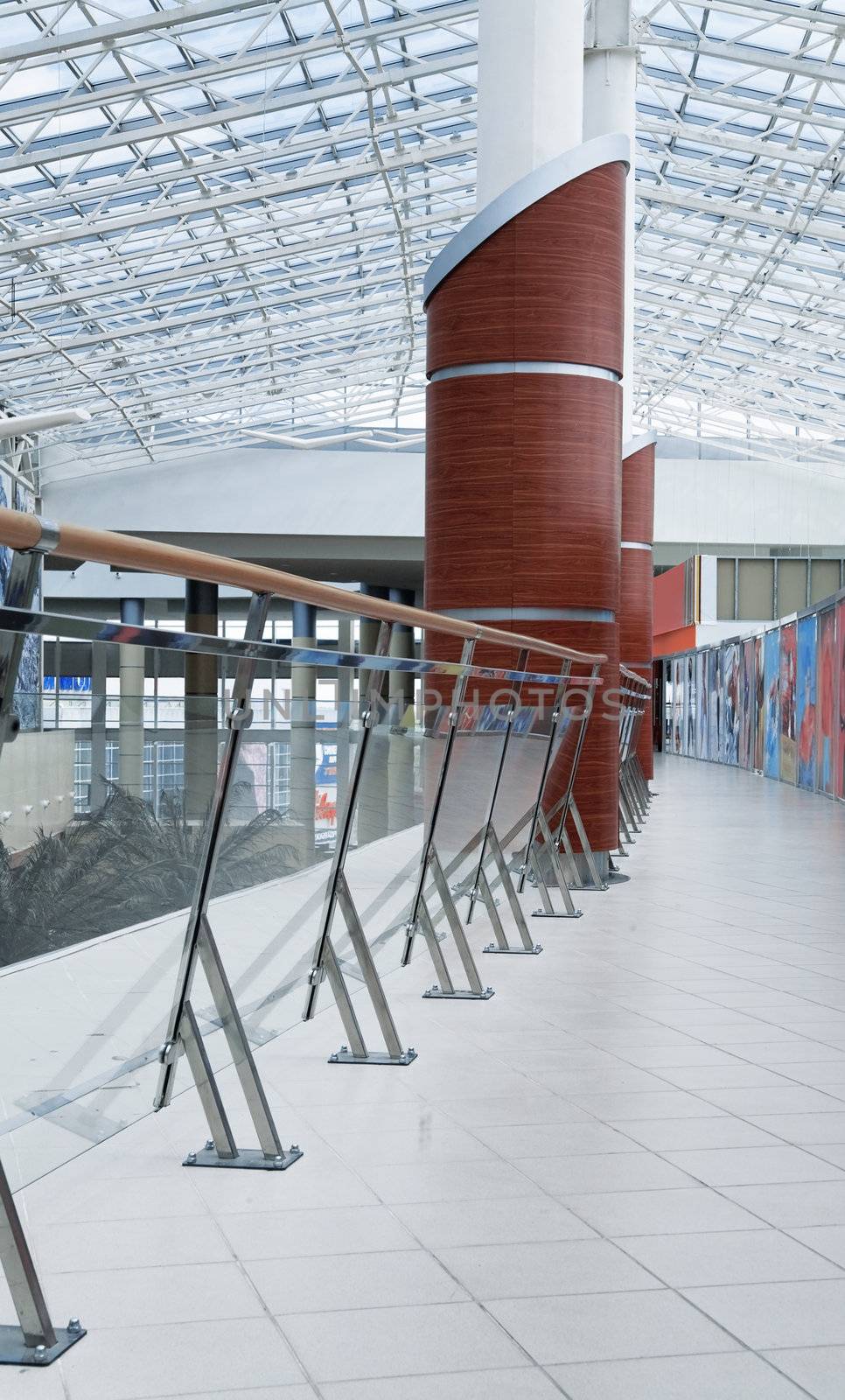 hall of modern office building with a glass handrail and a column by Serp