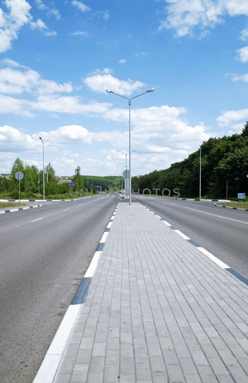 asphalt road with a divider for pedestrians