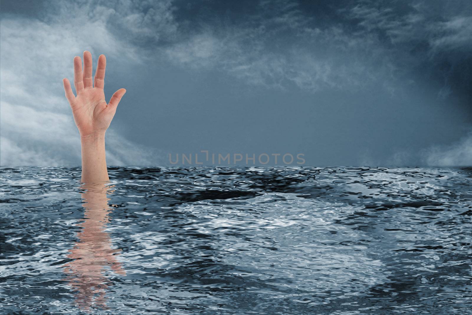 Person asking for help with his hand while drowning.