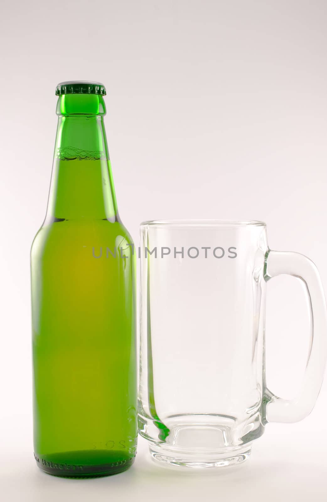 bottle and glass of beer on white background