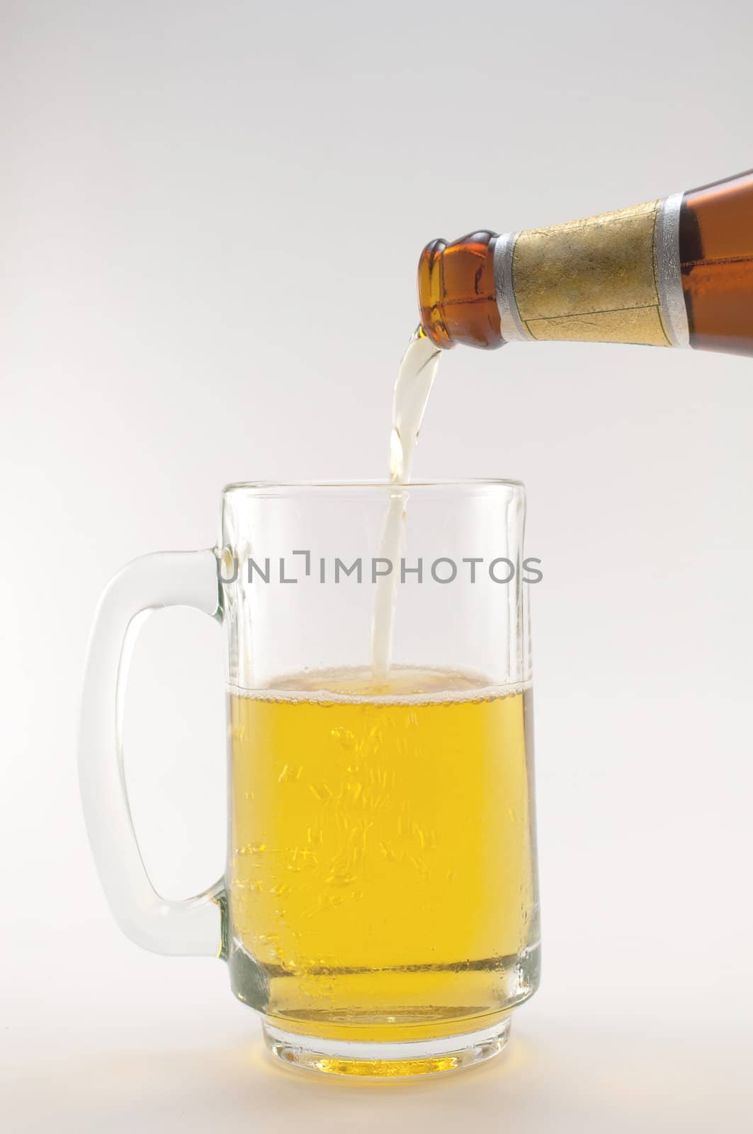 bottle and glass of beer on white background