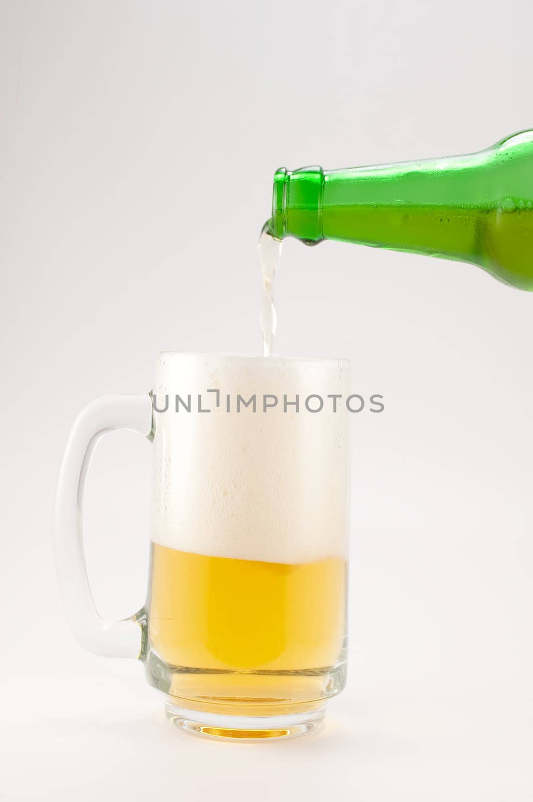 bottle and glass of beer on white background