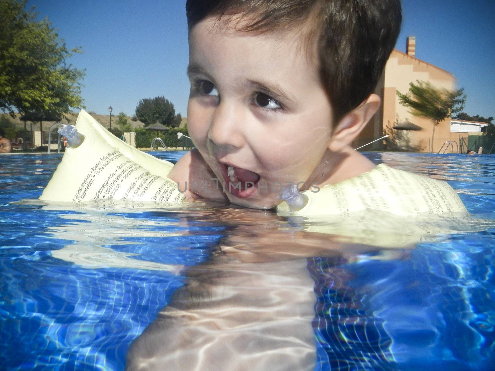 Boy swimming in a pool by FernandoCortes