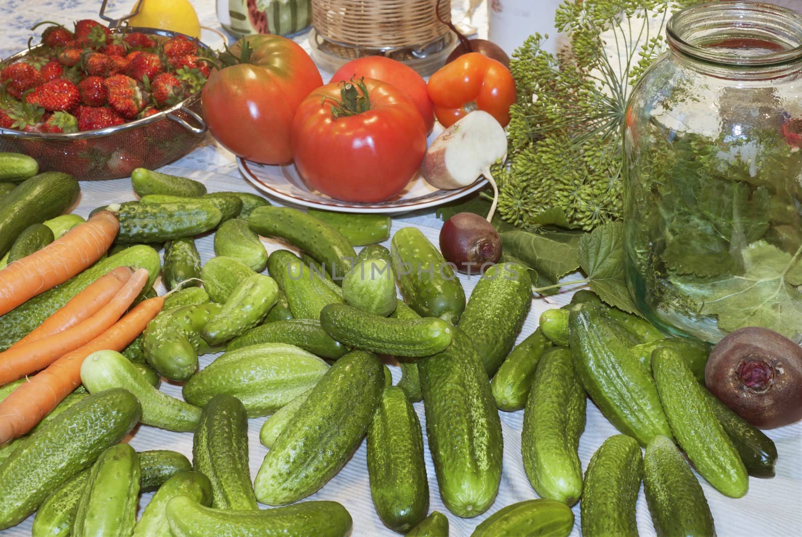 A variety of vegetables are on the kitchen table