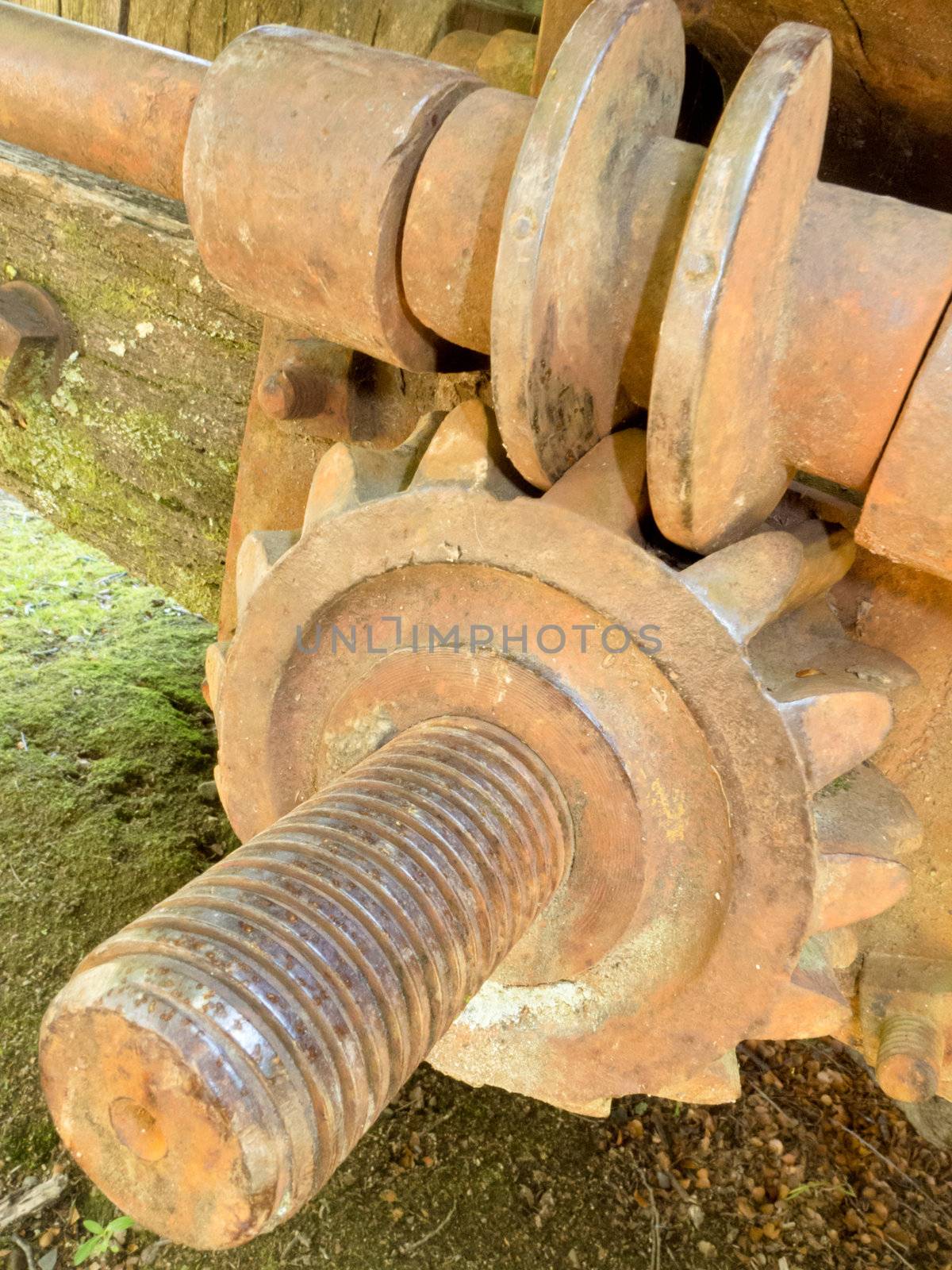 Close-up of old historic rusty iron worm gear with cogweel and threaded axle