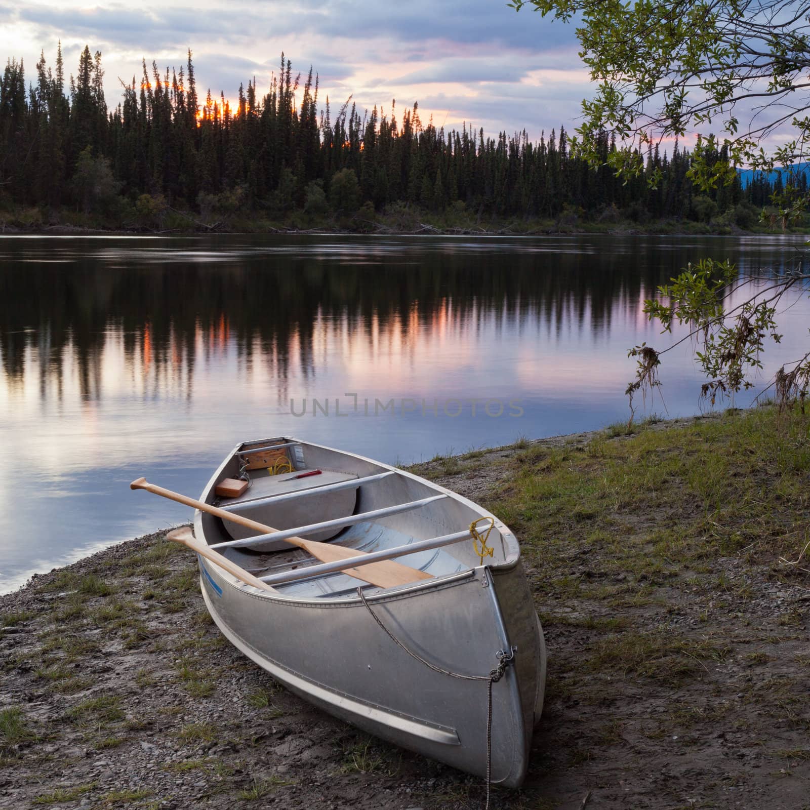 Sunset sky and canoe at Teslin River Yukon Canada by PiLens