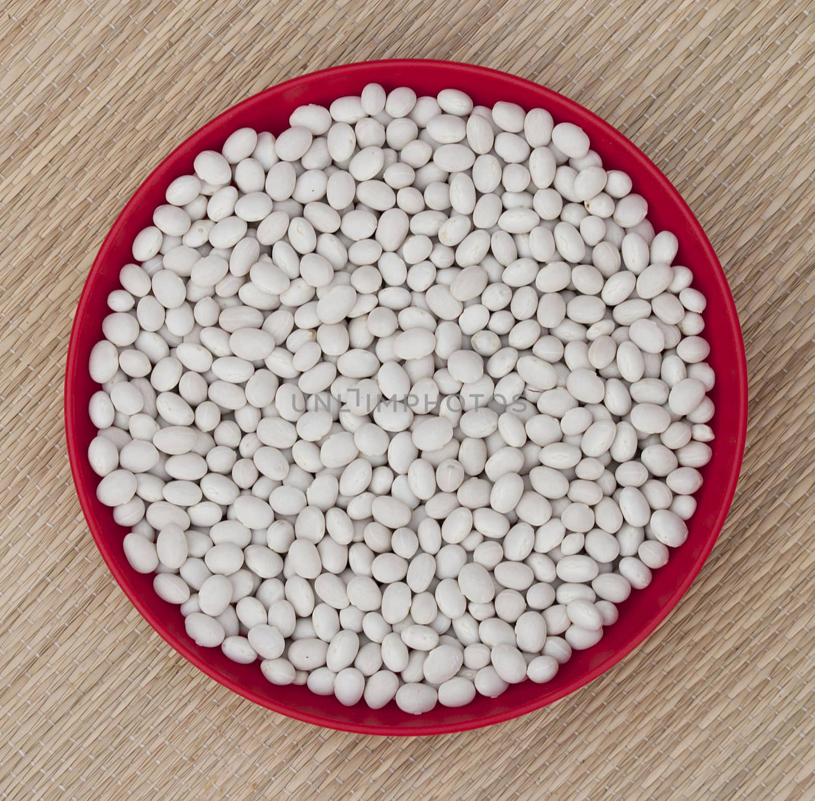 White beans in a round red bowl
