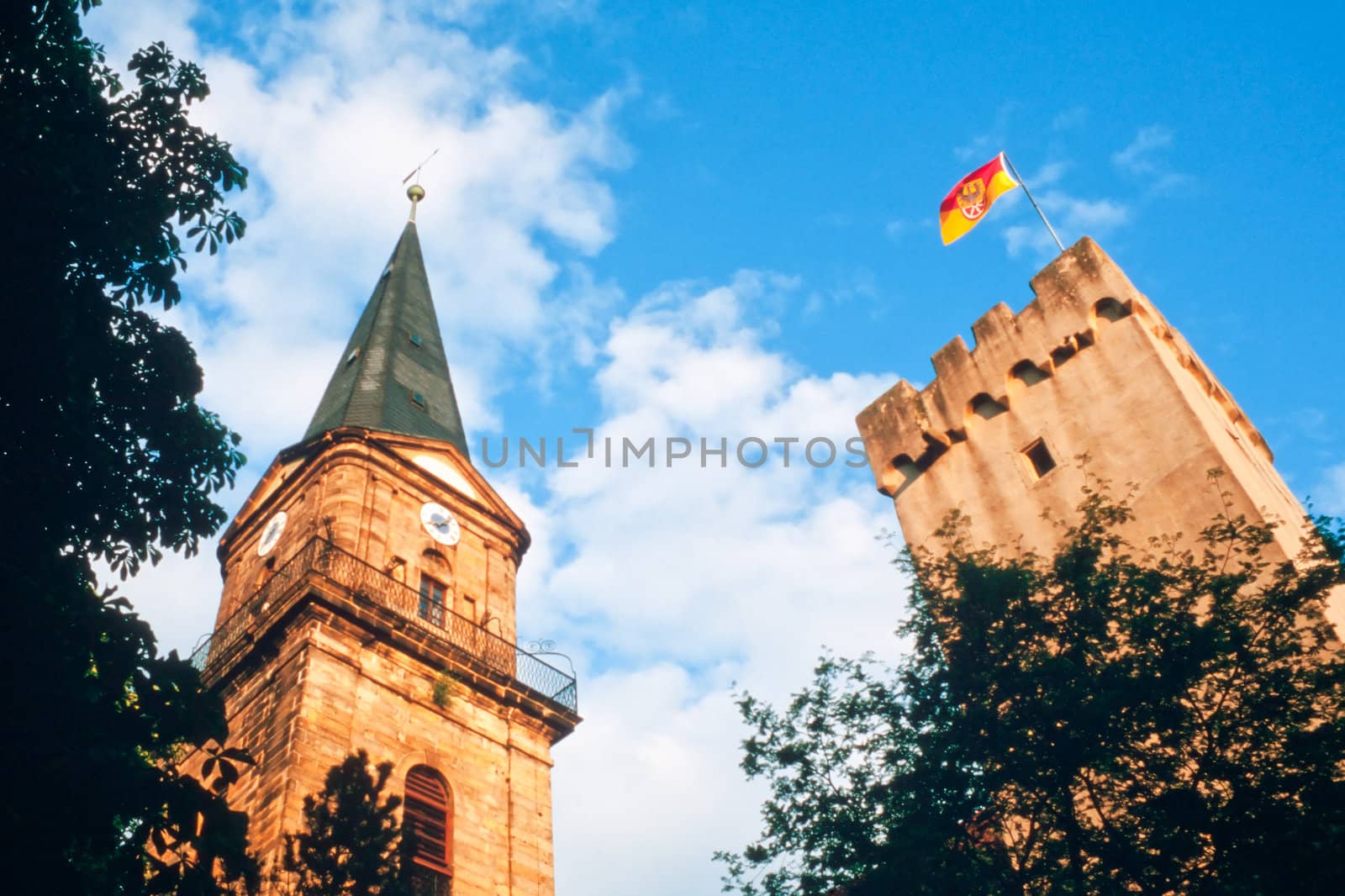 Historic church spire and city tower of Marktredwitz in Germany, Europe, flying a flag showing the city arms