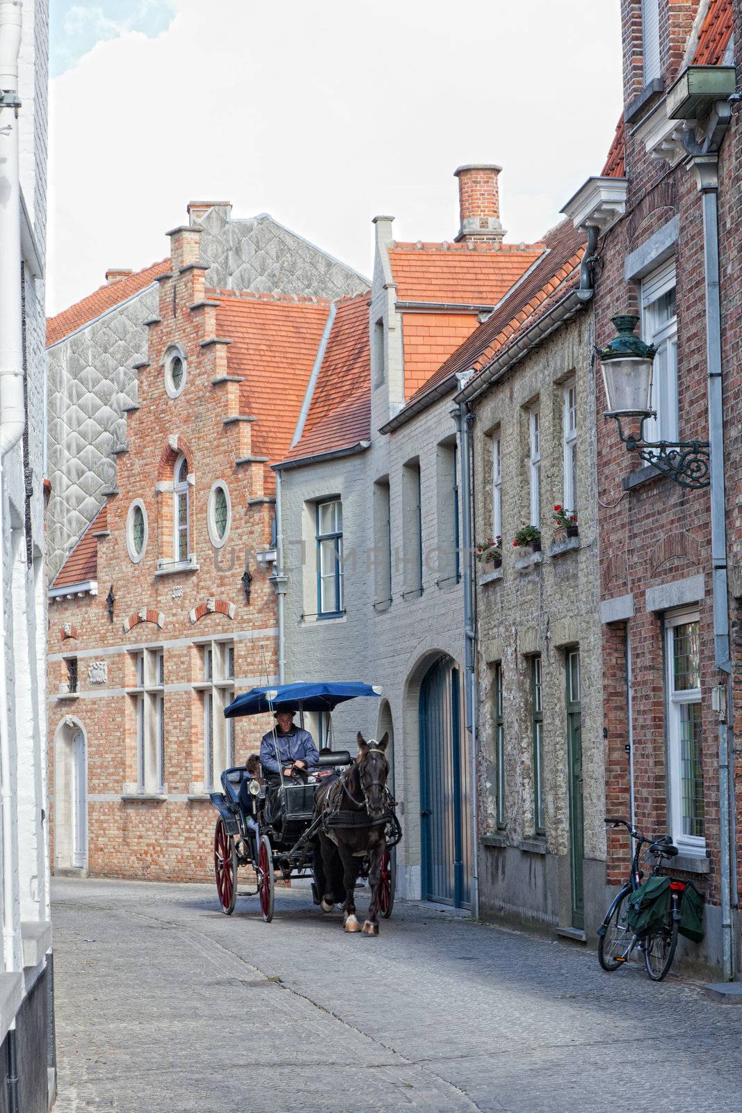 driver to carry tourists down the street , Bruges, Belgium, 29.09.2012. Bruges . the main town of the Belgian province the Western Flanders. One of the most picturesque cities of Europe.