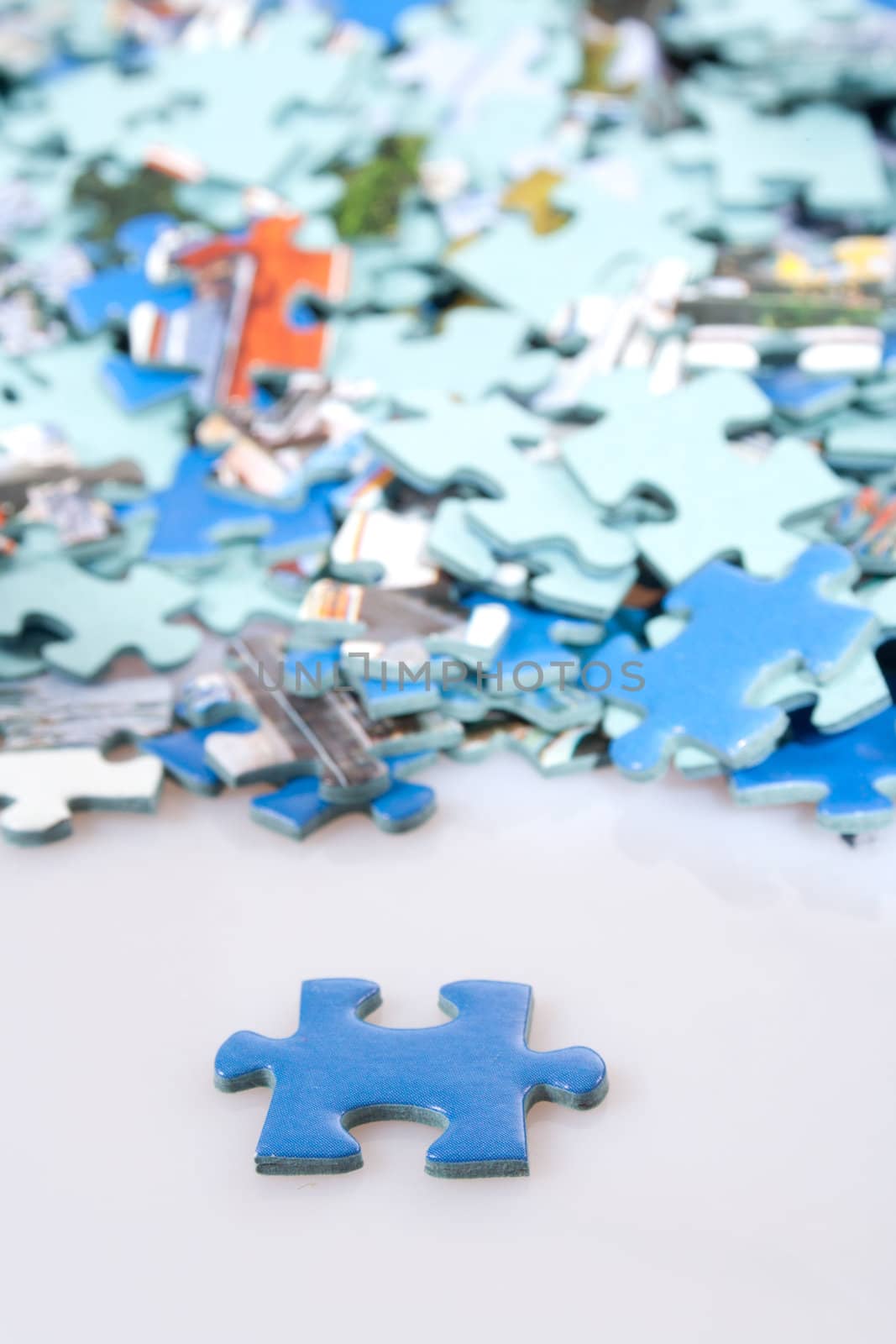 Pieces of puzzle spilled on table, abstract background 