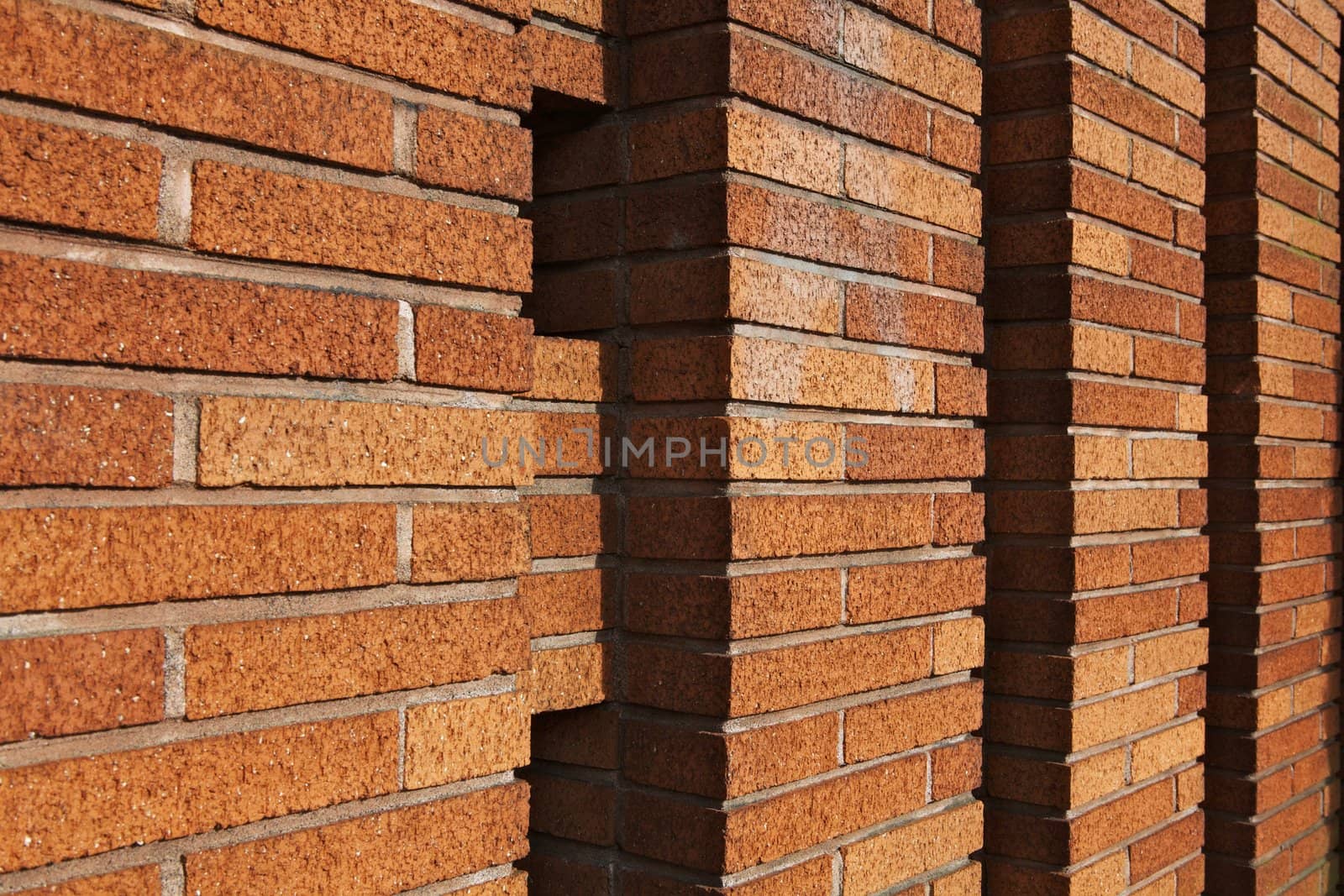 Perspective view of a tan brick wall built in columns