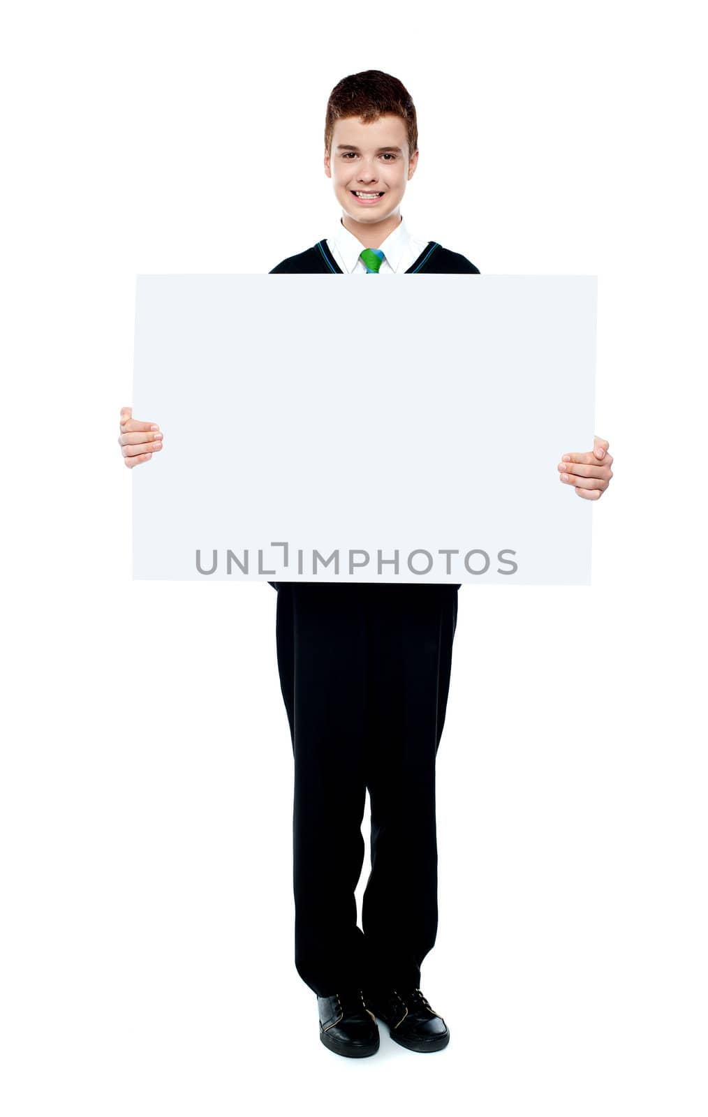 Young boy showing blank billboard against white background