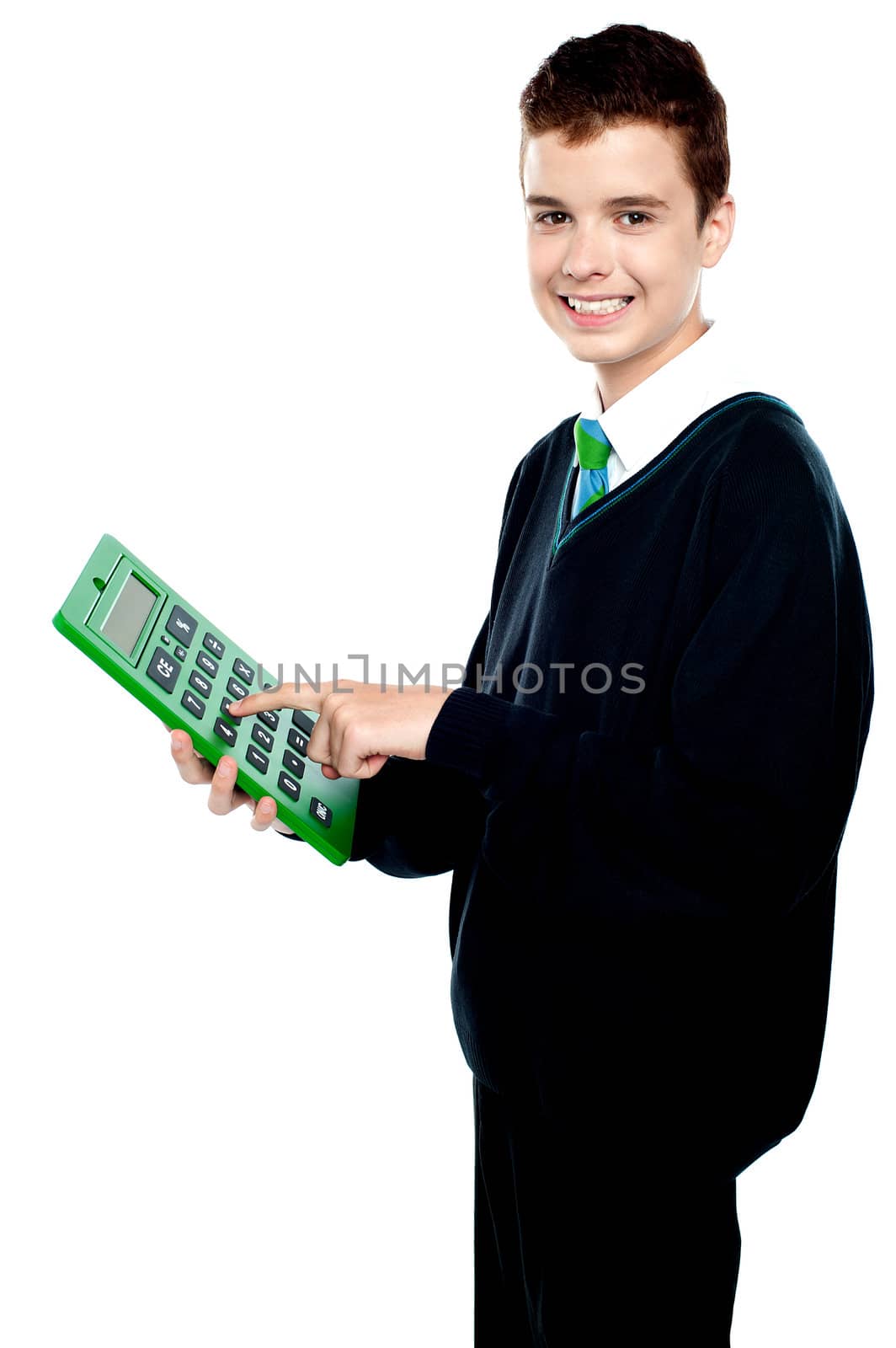Charming smiling school kid operating calculator and looking at camera