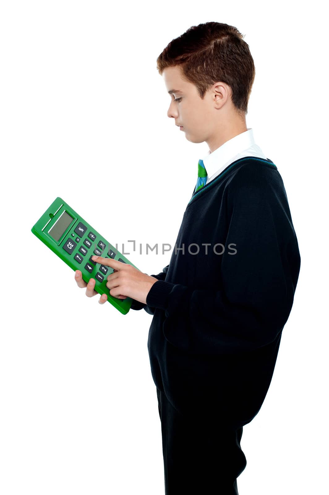 Serious school boy using big green calculator. Side view