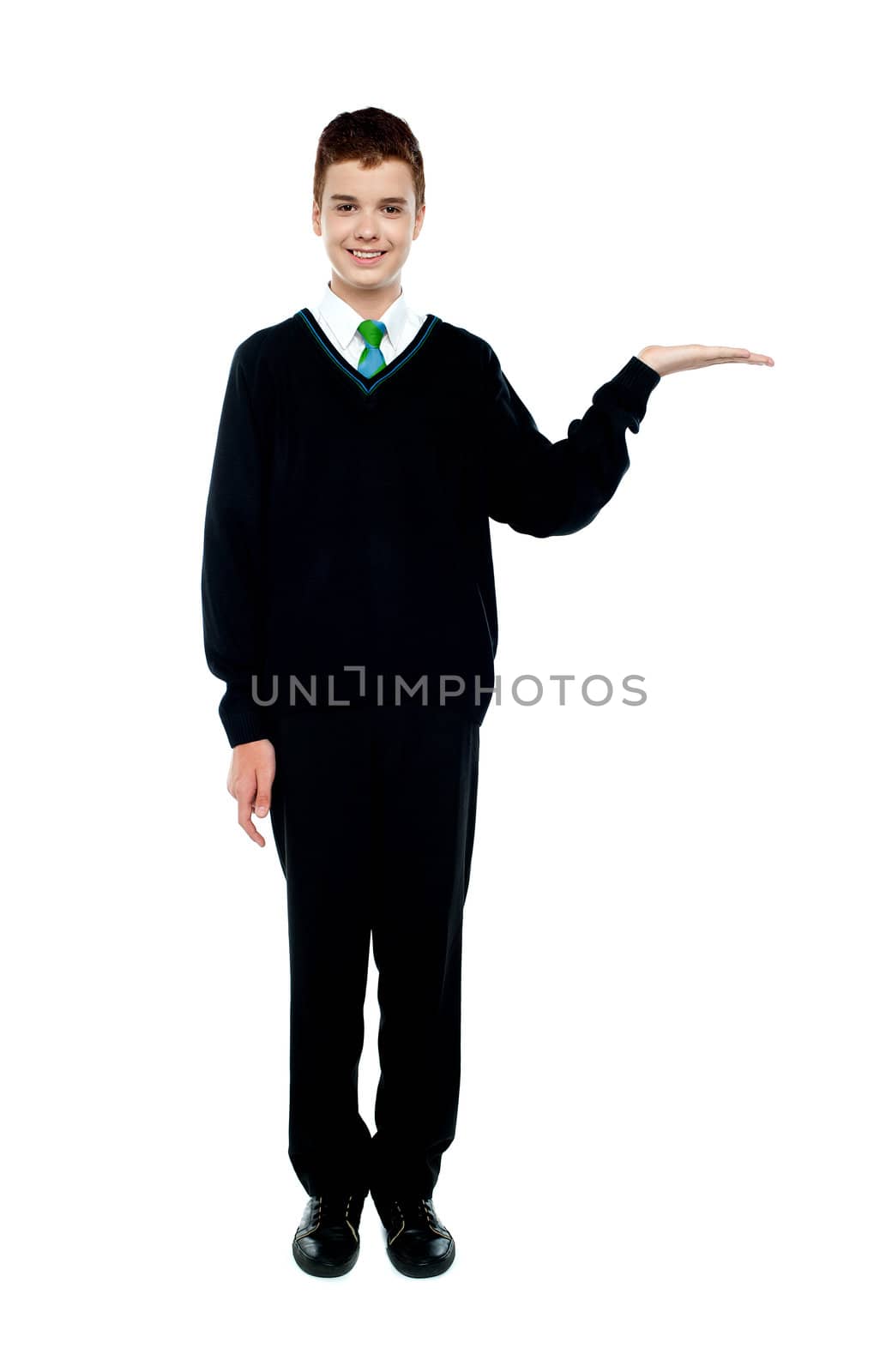 Full length shot of boy presenting copy space isolated over white