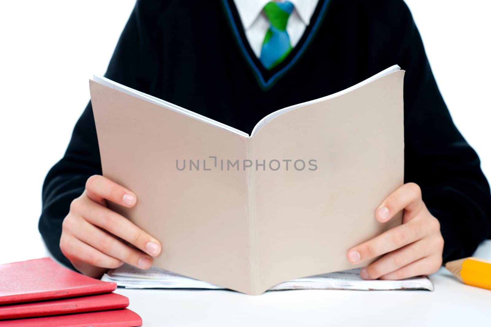 Cropped image of a school boy holding books against white background