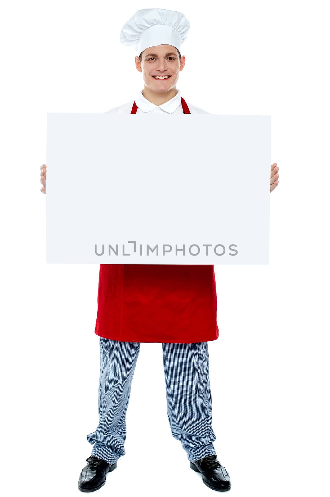 Chef holding blank advertising board, full length portrait