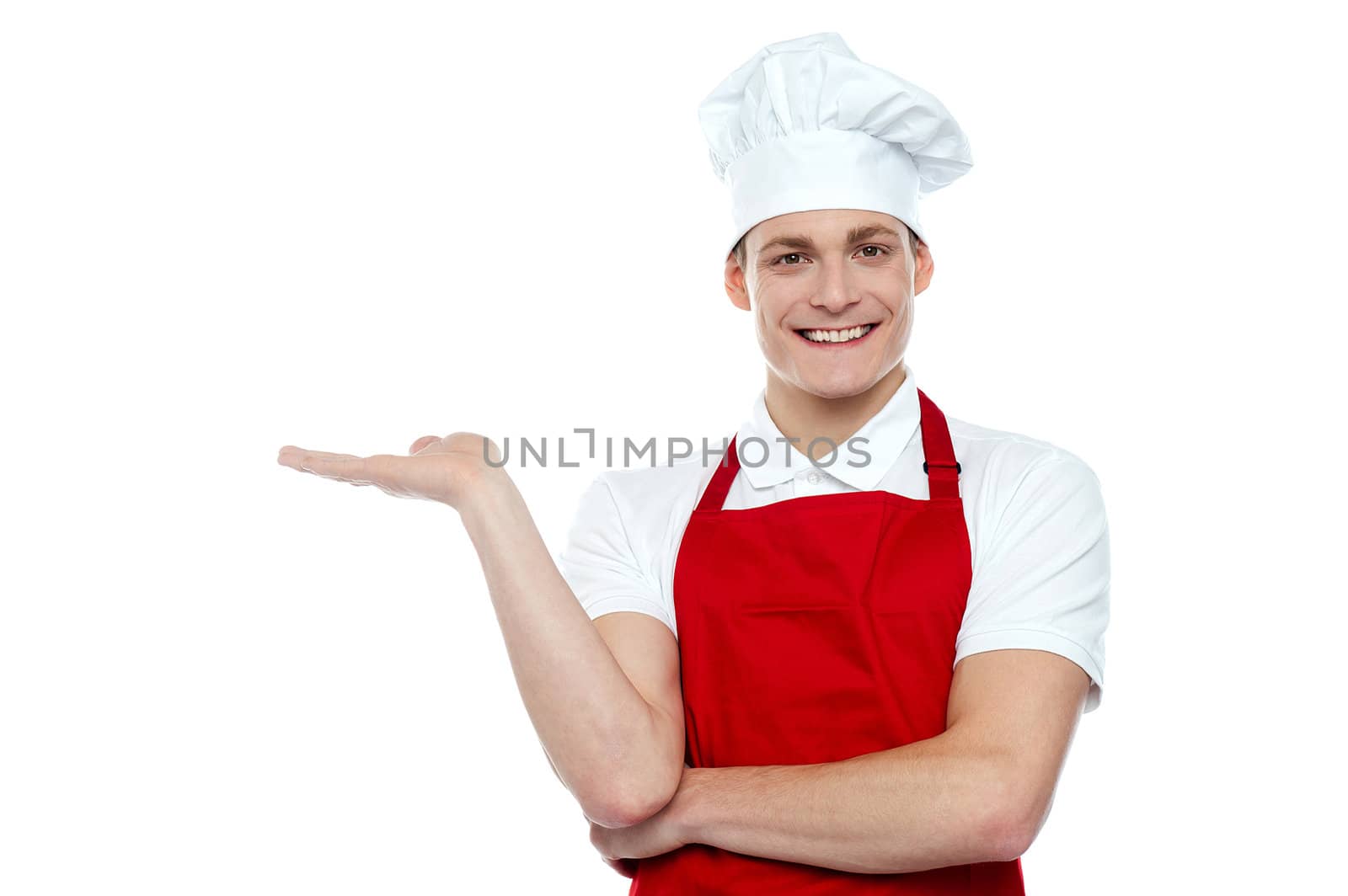 Portrait of handsome young chef presenting copy space