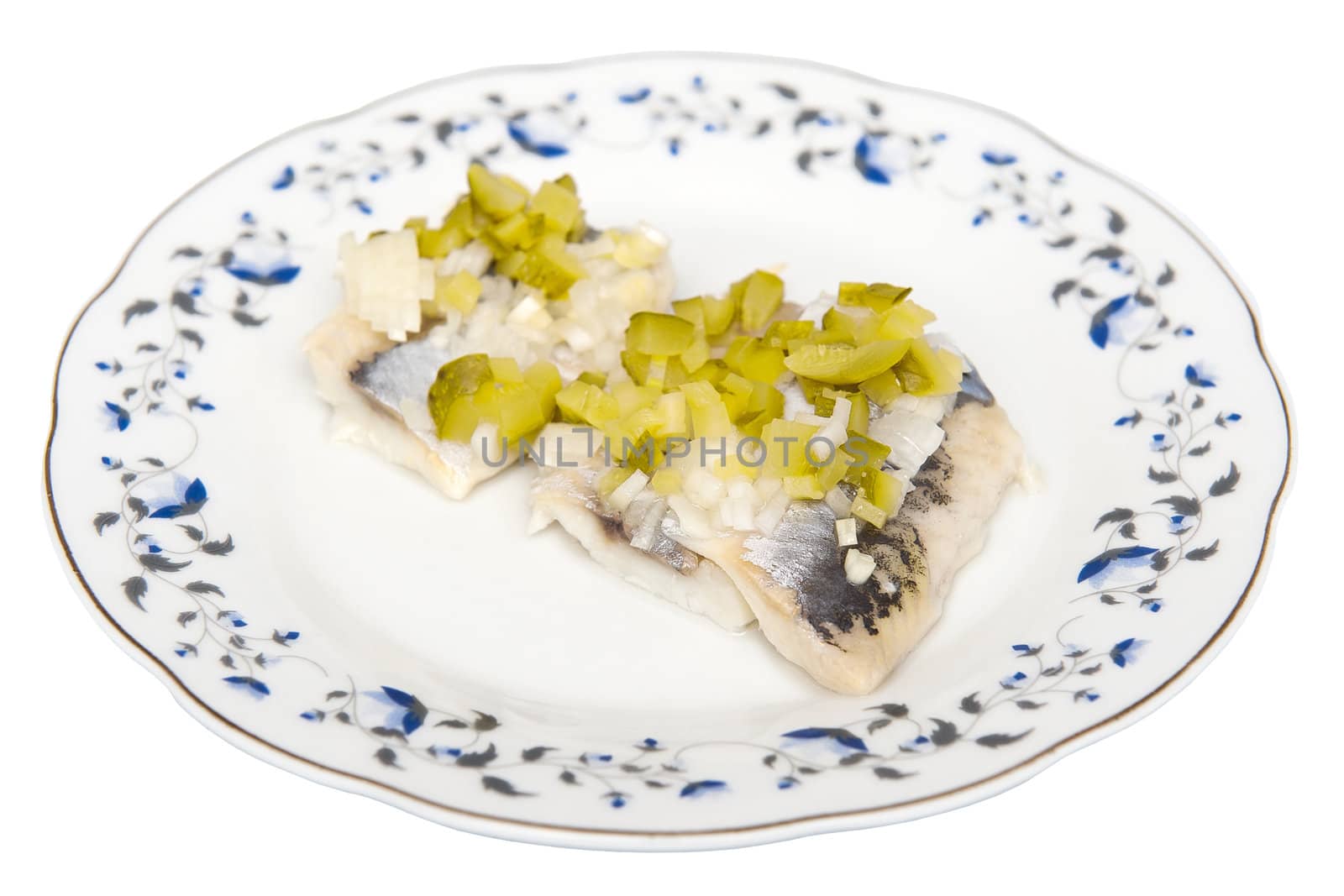 Herring with cucumber on the white plate