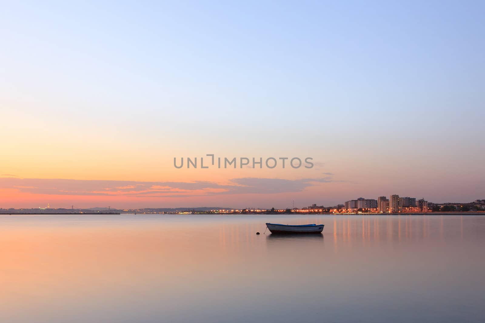 Boat on the tejo river and the city on background.