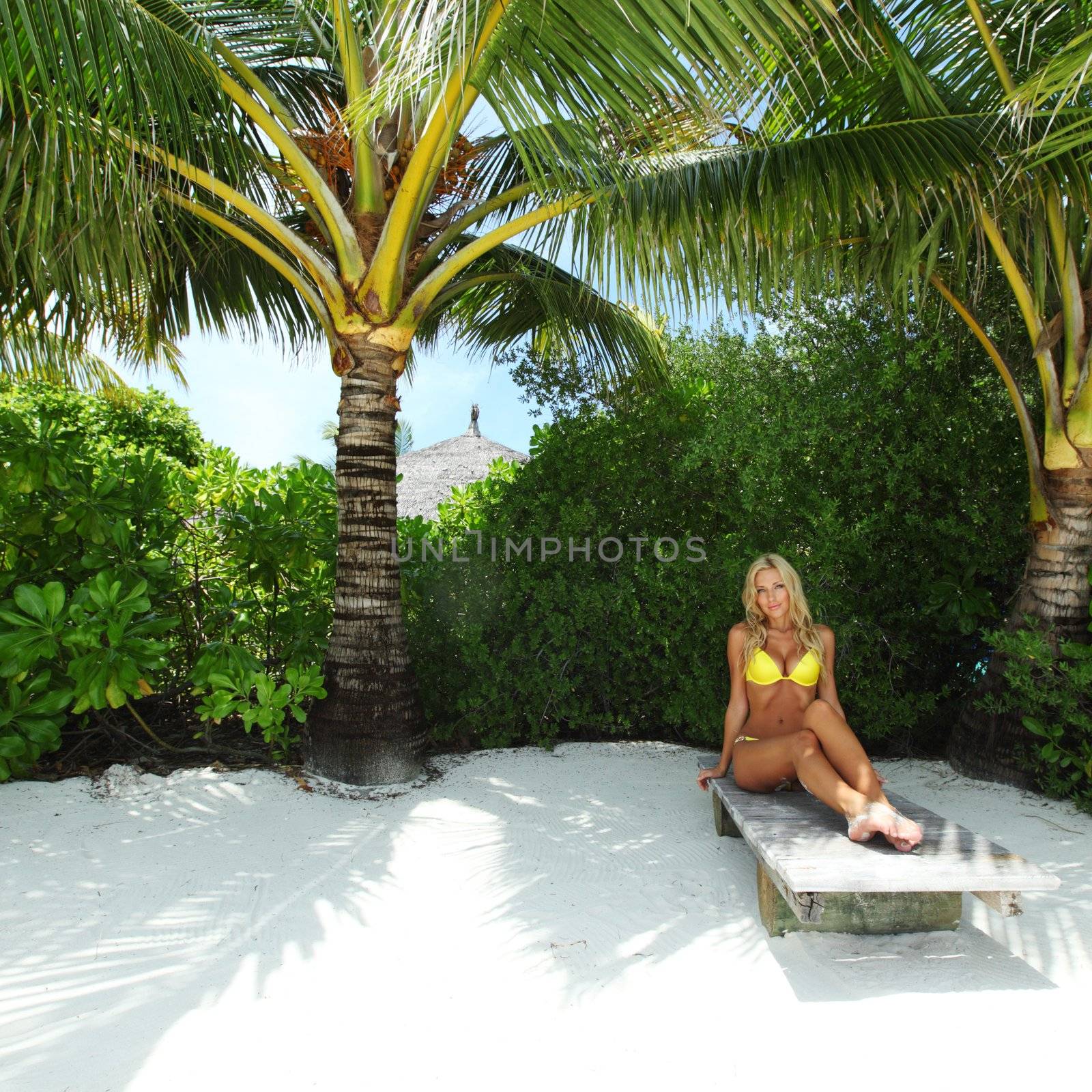 tropical woman on lounge by Yellowj