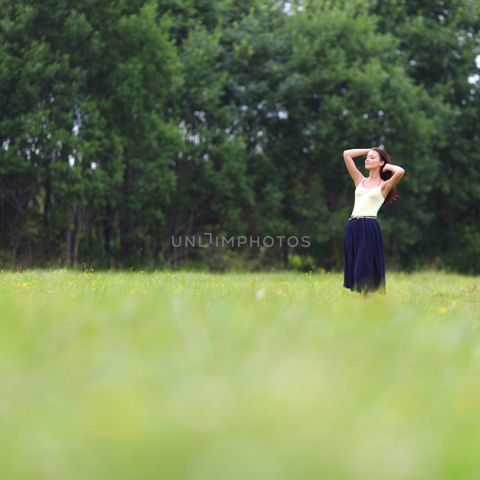 woman on green grass field by Yellowj