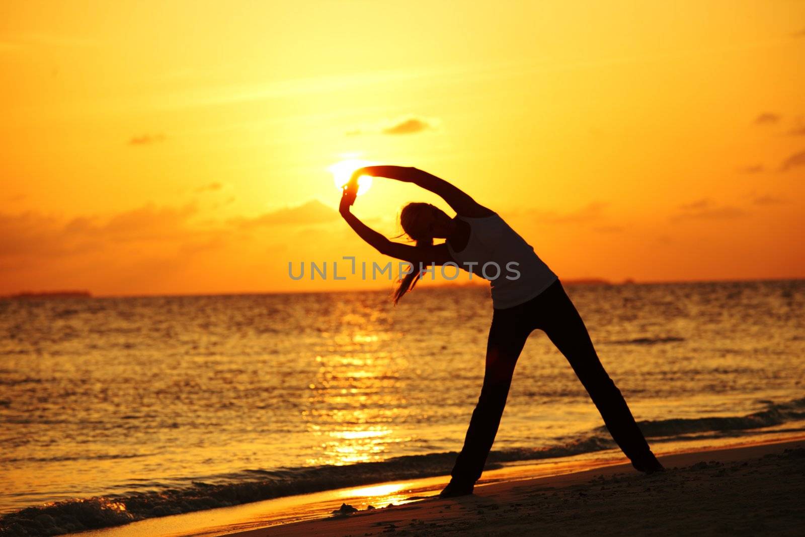 sunset yoga woman on sea coast