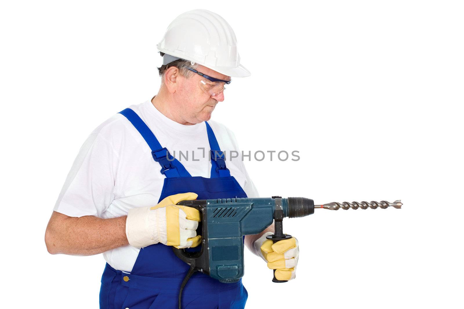 A construction worker holding drill for concrete and wearing proper safety equipment according to OSHA regulations, isolated on white background