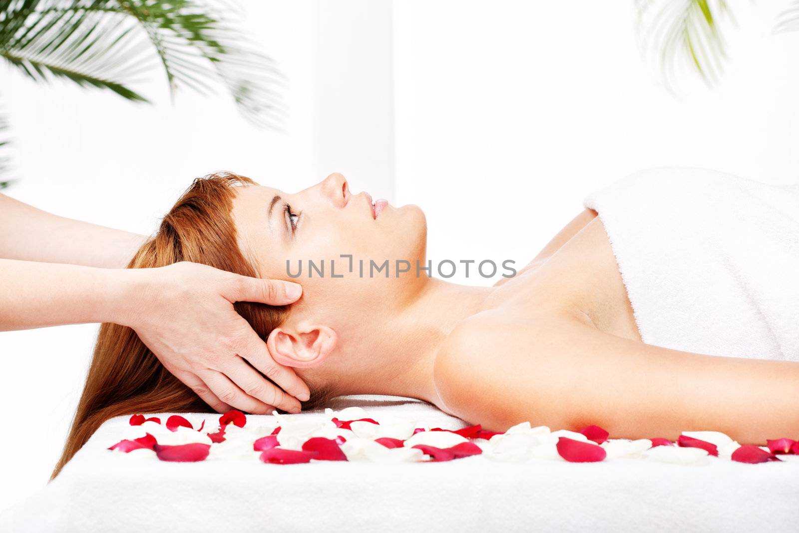 Pretty woman on head, temple, massage treatment in salon