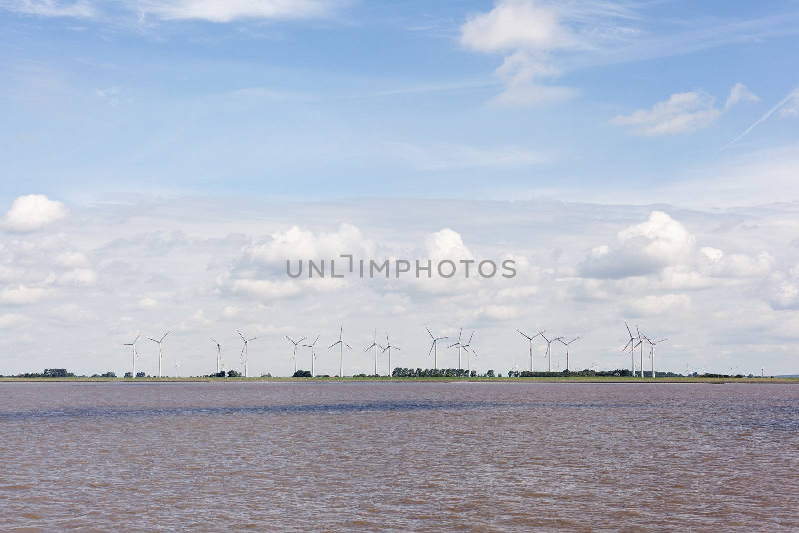 Wind turbines near river by imarin