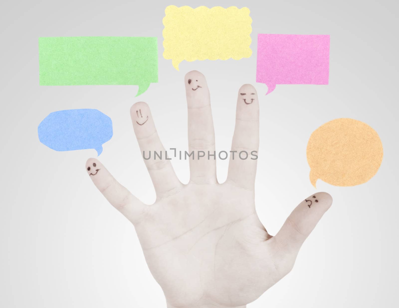 Happy group of finger smileys with social chat sign and speech thought. Fingers representing a social network.