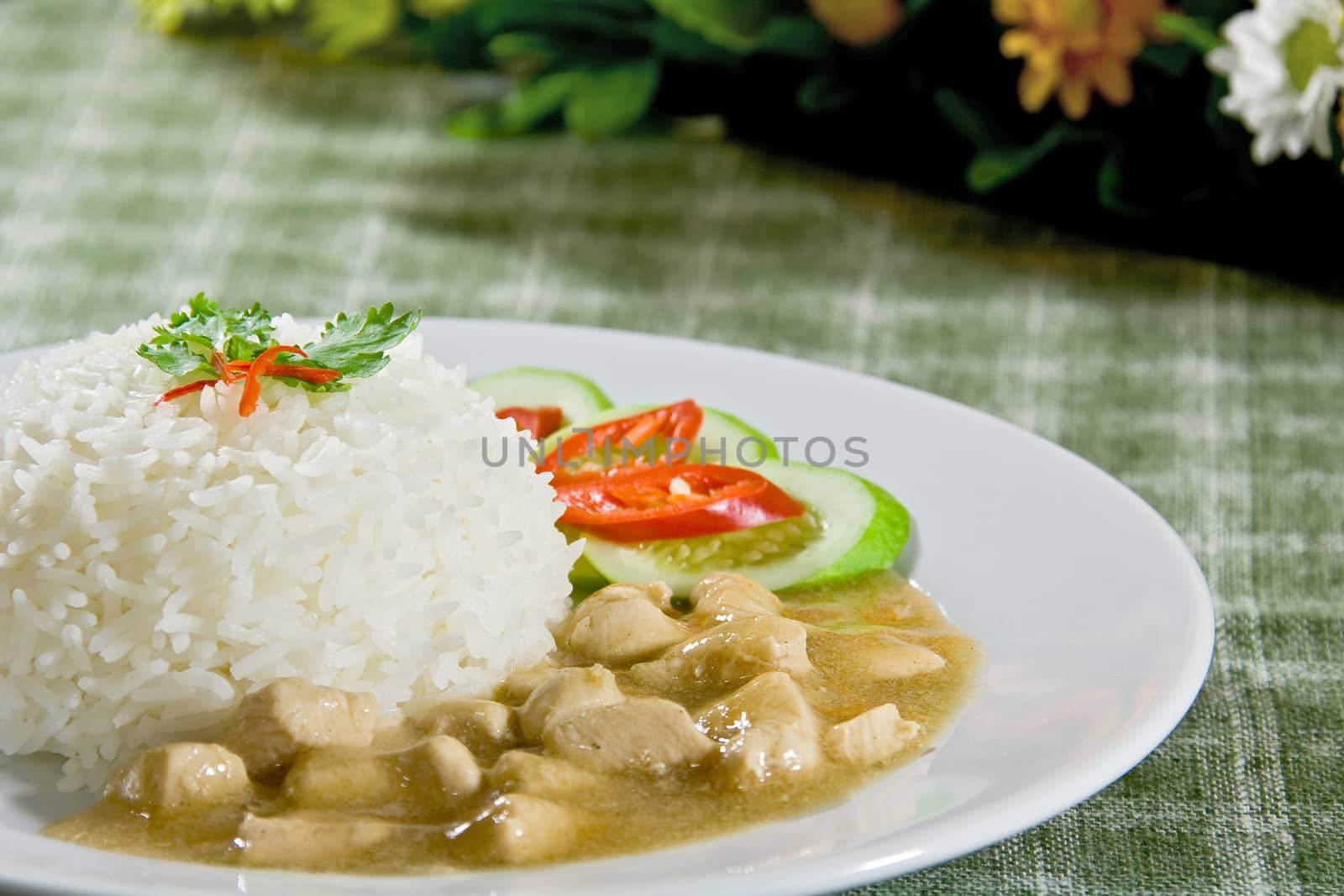 rice and Chicken in gravy sauce with cucumber and chili