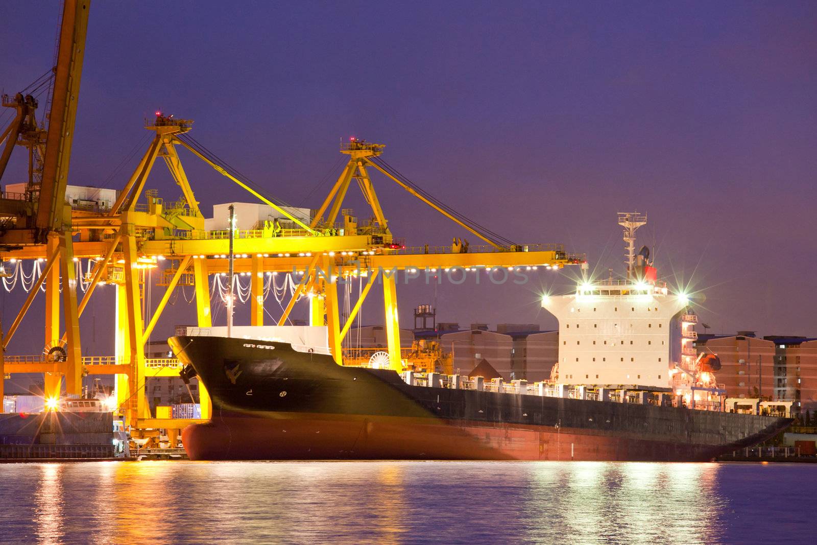 Container Cargo freight Industrial ship with working crane bridge unloading and loading goods in Bangkok shipyard Terminal at dusk for Logistic Import Export background