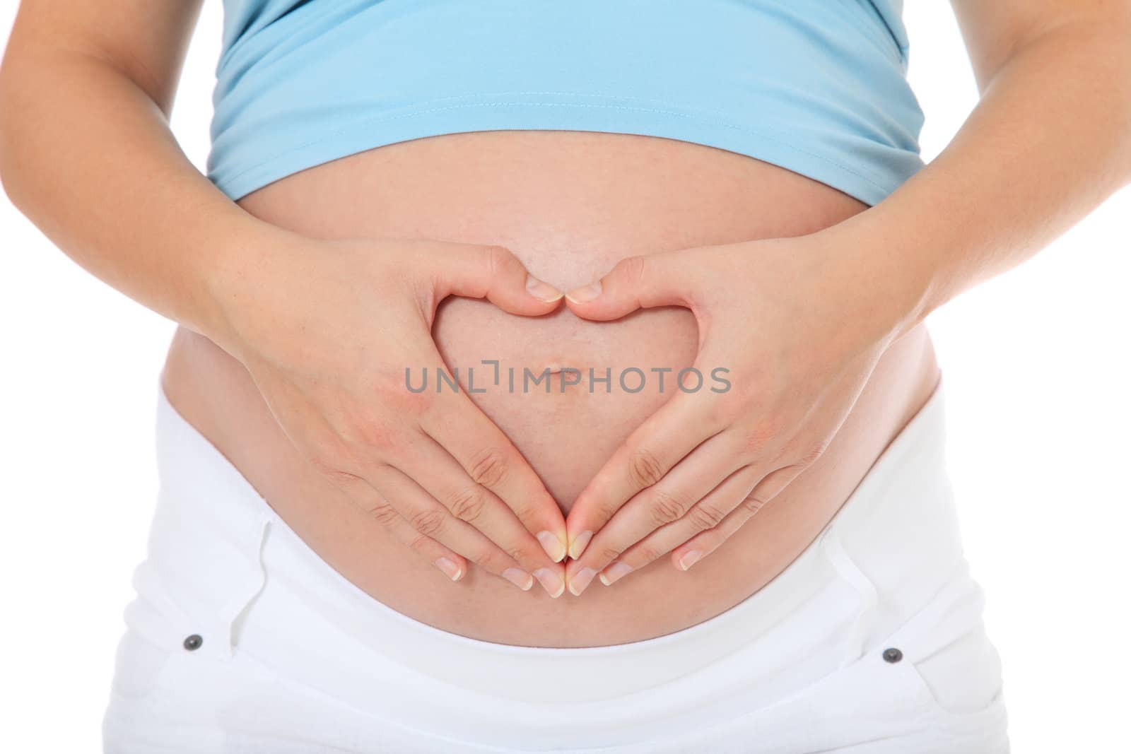 Pregnant woman forming heart out of her hands on her baby bump. All on white background.