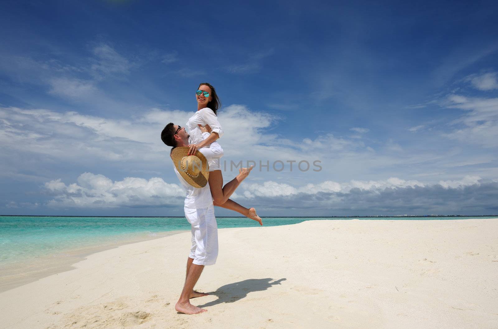 Couple on a beach at Maldives by haveseen