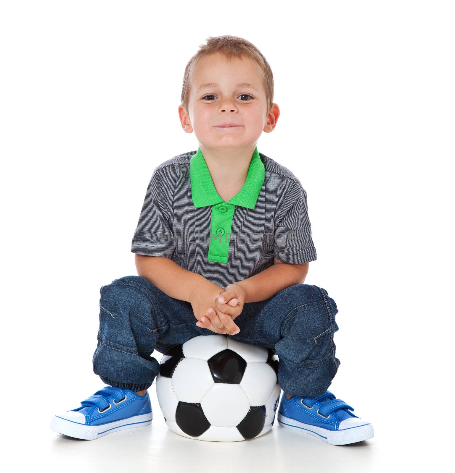Boy sitting at soccer ball by kaarsten