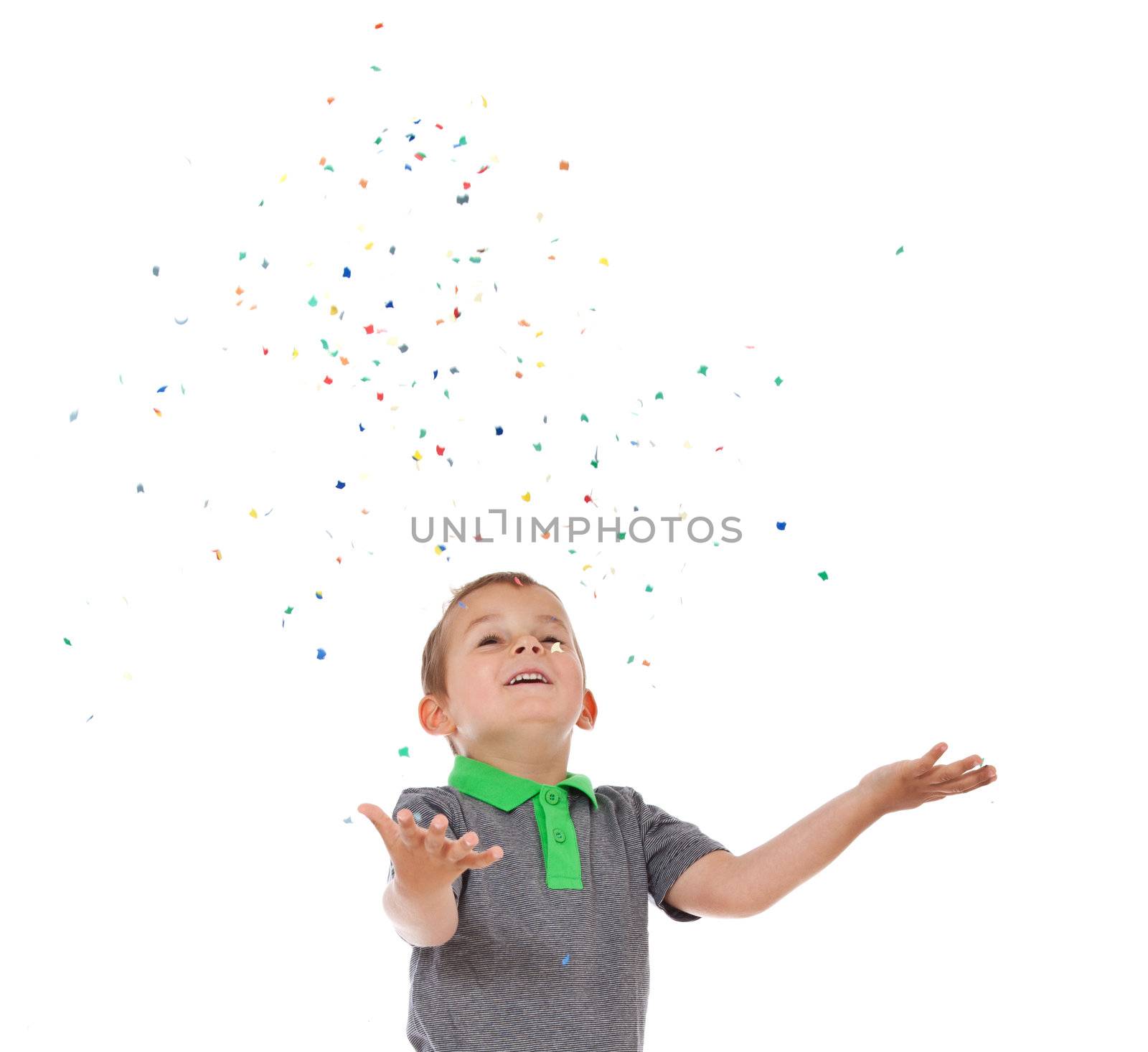 Cute little boy having fun with confetti. All isolated on white background.